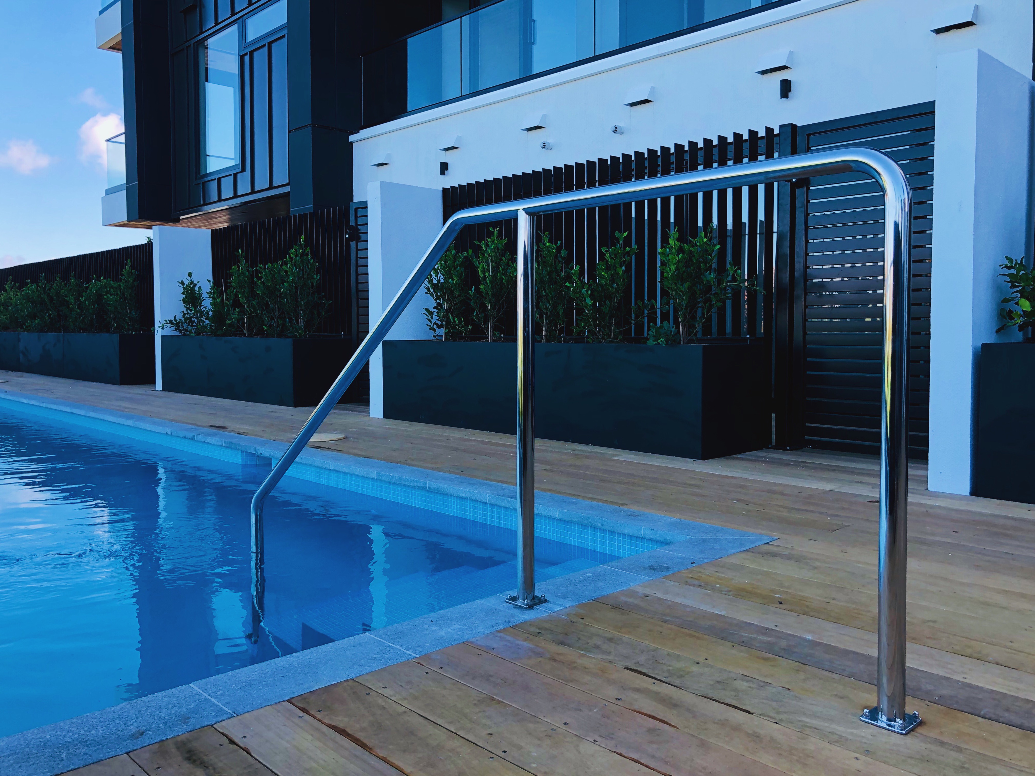 Image of a custom made stainless steel pool handrail for a residential apartment building.