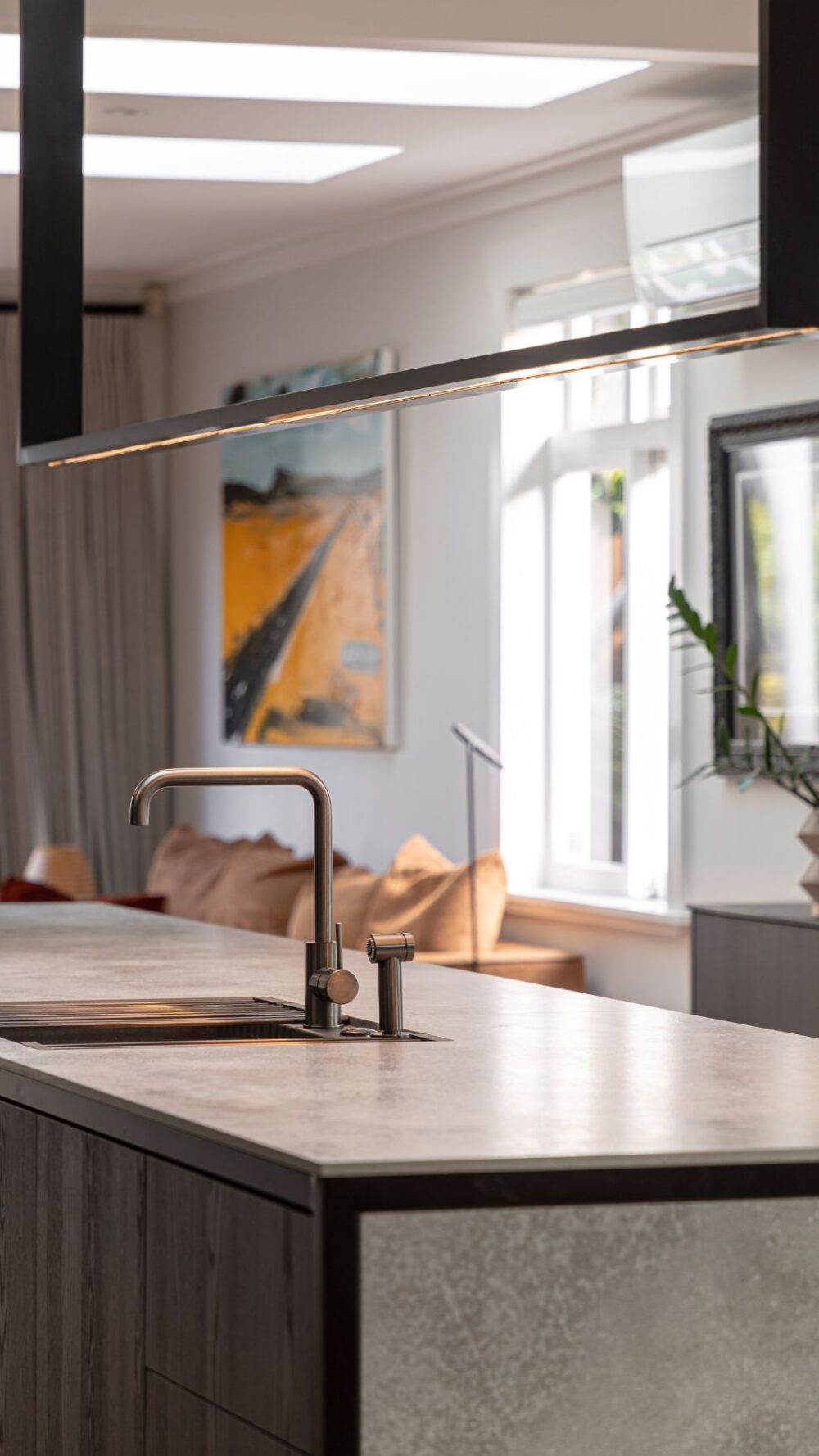 Image of a high-spec designed kitchen featuring a custom made rectangular industrial feature light. Crafted for Sticks + Stones Design.