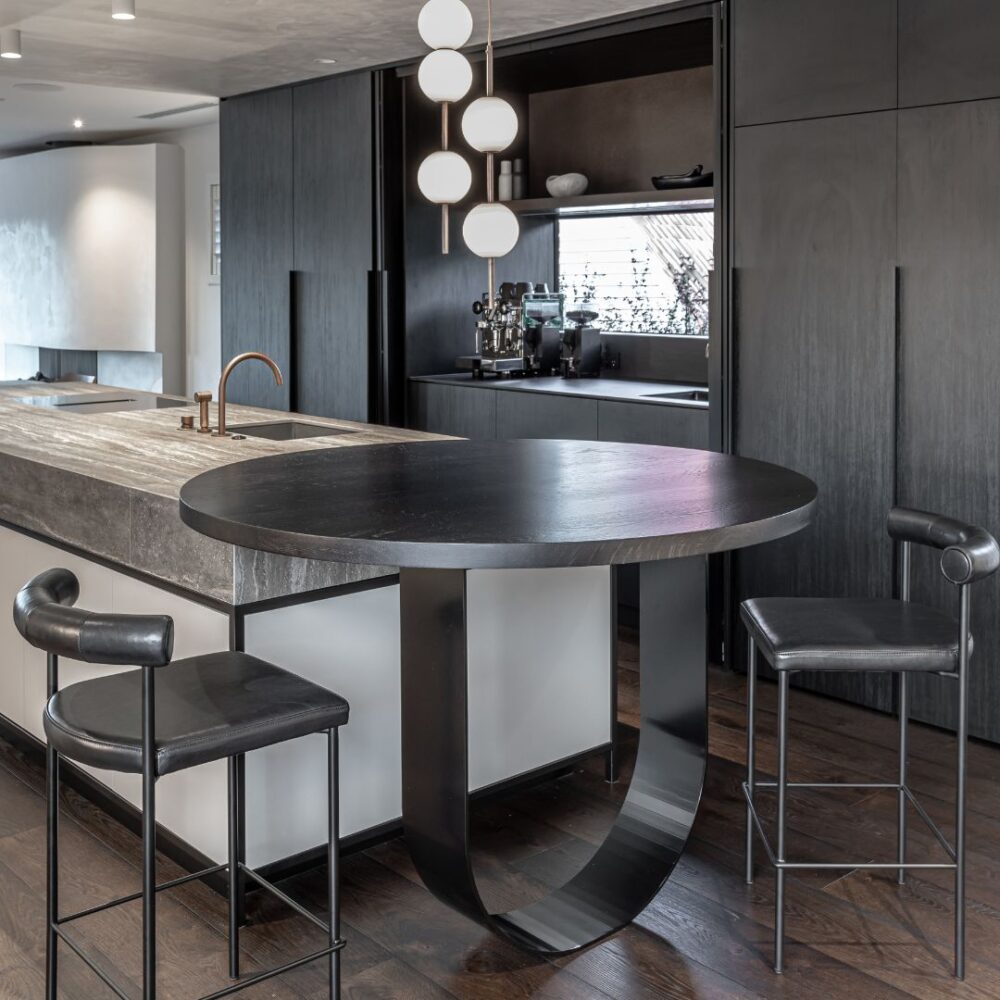 Image of a high-spec designed kitchen featuring a custom made curved table based fabricated from mild steel and powder coated black. Crafted for Sticks+Stones Design. Custom-residential-fabrication_Curved-table-base_SticksStones-Design