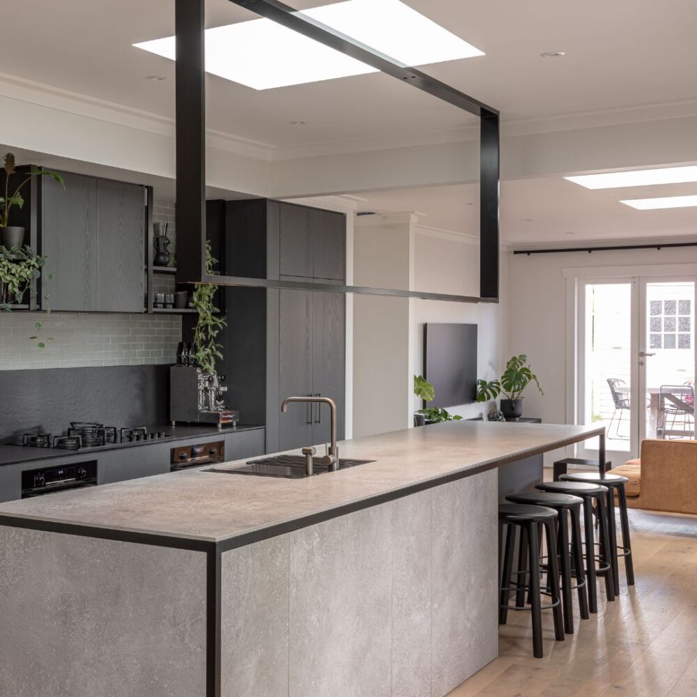 Image of a high-spec designed kitchen featuring a custom made rectangular industrial feature lighting. The light is fabricated from mild steel and powder coated black. Crafted for Sticks+Stones Design.